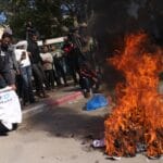 Palestinians burn ‘humiliating’ shirts after release from Israeli prisons | Israel-Palestine conflict News
